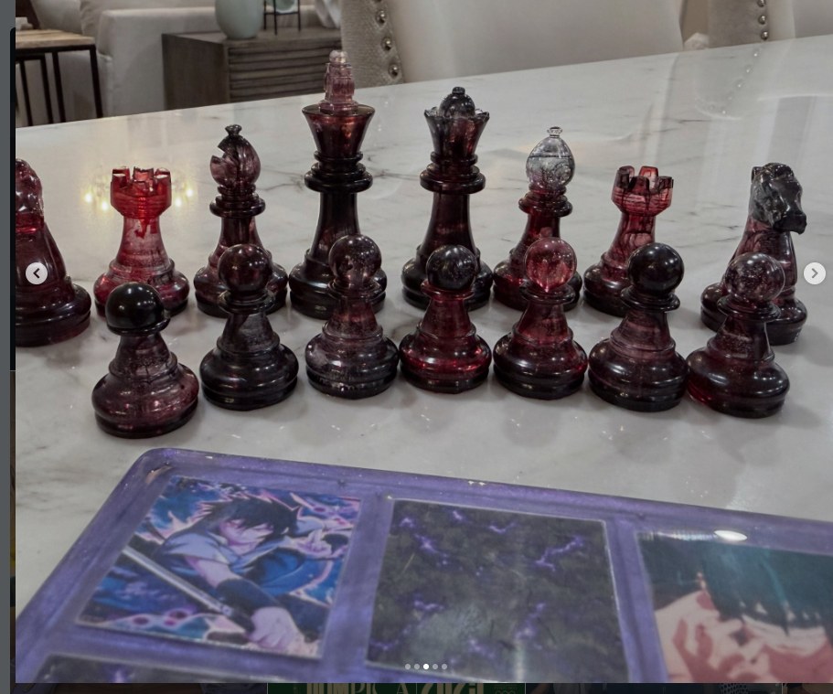 Hand-cast garnet red resin chess pieces on marble
