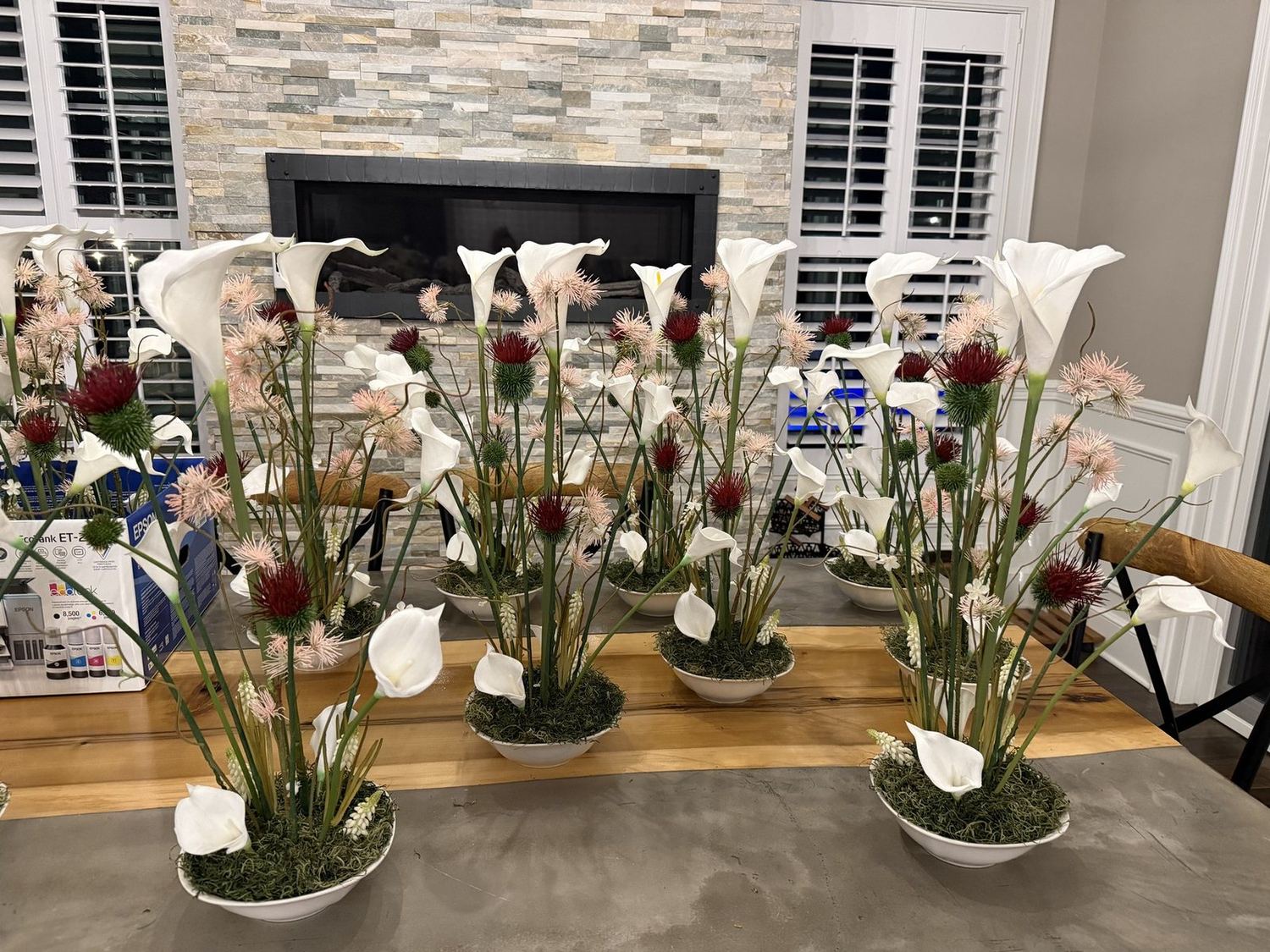 Row of white calla lily centerpieces designed in studio