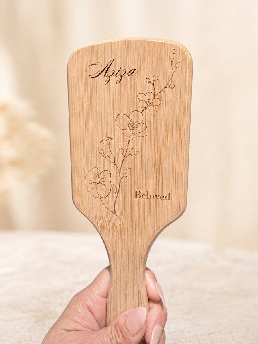 Engraved bamboo hairbrush personalized with a name and florals