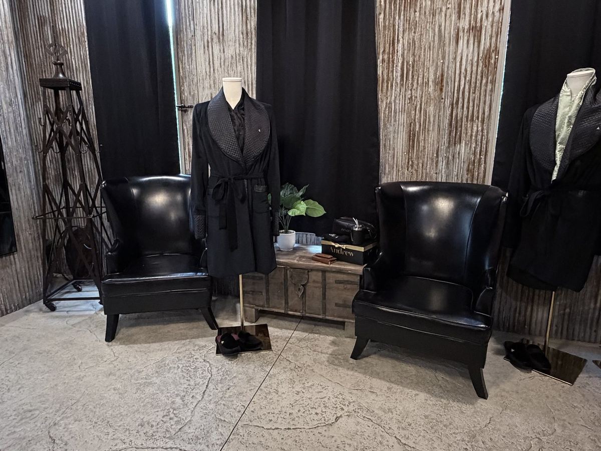 Groom suite styled with black robes and leather chairs
