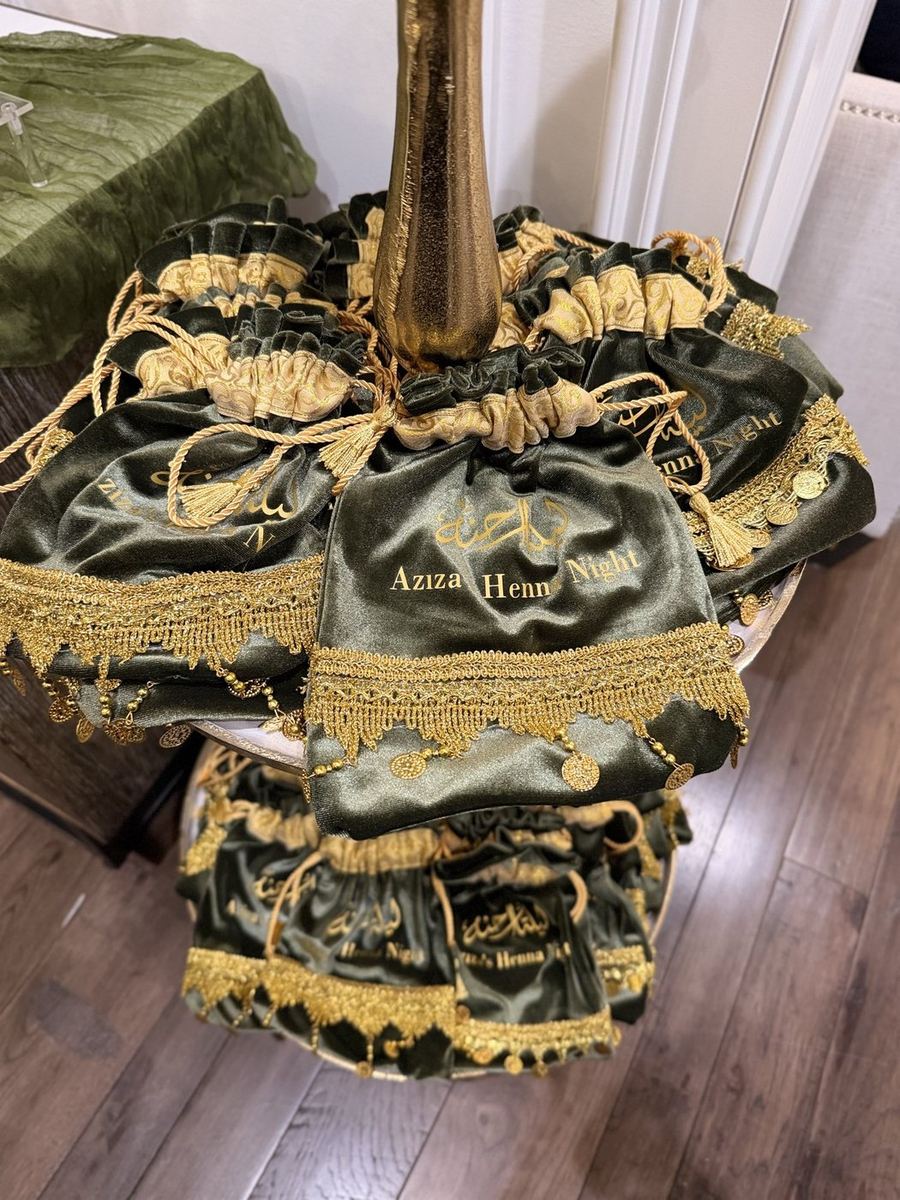 Tower of green velvet henna favor bags with gold coin trim