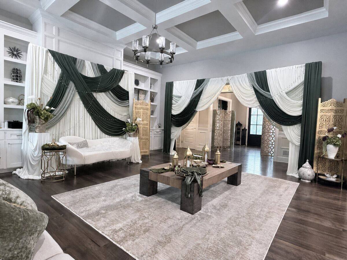 Lounge dressed in ivory and olive drapery with carved gold screens