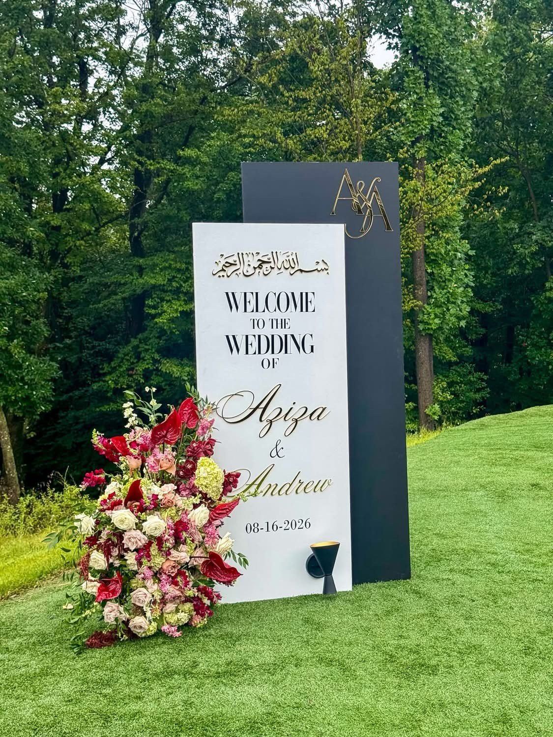 Custom wedding welcome sign with fresh floral arrangement outdoors